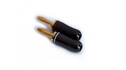 Gold plated red and black high quality banana plugs for cable speakers, isolated on white.