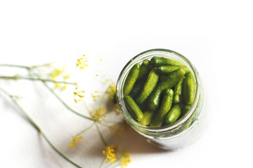 jar with pickled cucumbers on a white background. gherkins cucumbers.