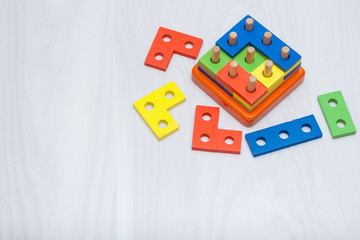 Colorful wooden toys for logical thinking, education. Copy space, top view. Logic game concept.