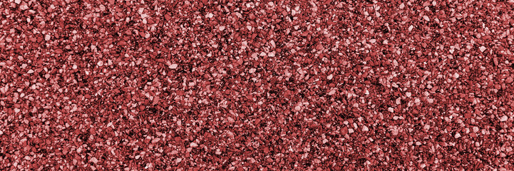 Closeup red bitumen shingle. Rough background made of roofing material