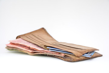 Brown men's wallet with money inside, credit card inside, placed on a white background