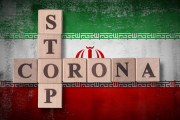 Flag of Iran with wooden cubes spelling STOP CORONA on it. 2019 - 2020 Novel Coronavirus (2019-nCoV) concept art, for an outbreak occurs in Iran.