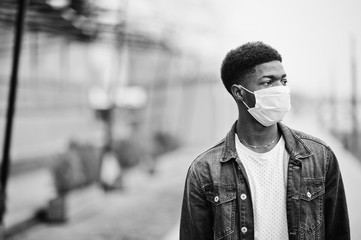 African man at park wearing medical masks protect from infections and diseases coronavirus virus...