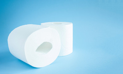 two Toilet paper roll on a blue background top view. Toilet paper purchase due to kronavirus concept. Personal hygiene and stopping the spread of the virus. Cleanliness, Hygiene, Sterility copy space