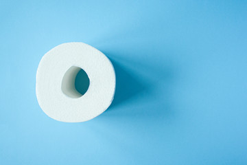 Toilet paper roll on a blue background top view. Toilet paper purchase due to kronavirus concept. Personal hygiene and stopping the spread of the virus. Cleanliness, Hygiene, Sterility copy space