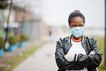 African girl at park wearing medical masks protect from infections and diseases coronavirus virus...