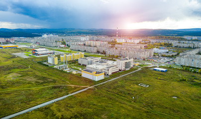 Aerial view of modern small town. Sunset over the city