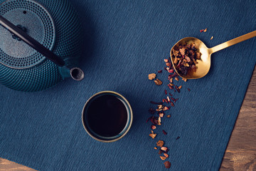 Traditional tea ceremony accessories, teapot and teacup with herbs and dry fruits tea. Destressing,...