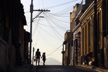 Silhouettes of people on the street of Santiago de Cuba, Cuba - 332382966