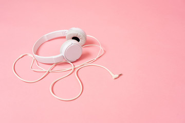 Music: White headphone on a pink background.