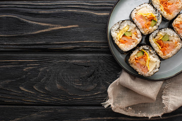 top view of plate with korean gimbap on wooden surface