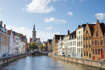 Canals of Bruges with the church of our lady in the background, Bruges, Belgium.