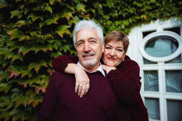 Elderly couple in love walking in the autumn park.