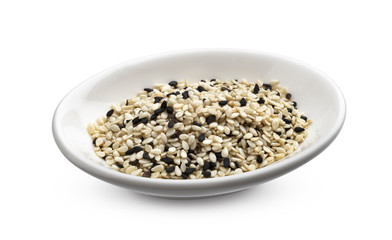 Black and white sesame seeds isolated on white background, macro