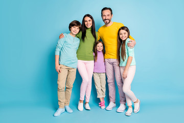 Fototapeta premium Full length body size view of nice attractive lovely charming ideal cheerful cheery family pre-teen kids mom dad embracing isolated on bright vivid shine vibrant blue color background