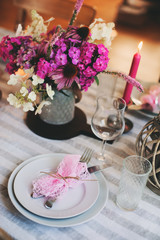 summer festive table details in pink, white and purple tones. Family romantic dinner or party in rustic country house.