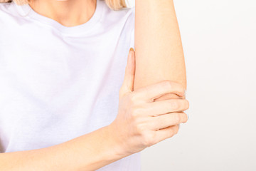 Woman suffering from chronic joint rheumatism. Elbow pain and treatment concept