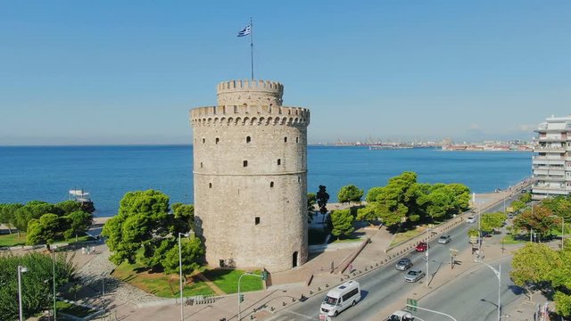 Aerial shot view, flying above Greek town Thessaloniki and famous UNESCO world heritage White tower, historic monument from medieval roman empire ages. 