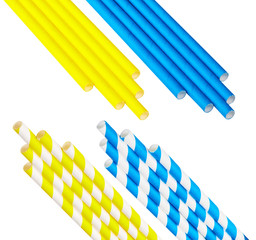 Yellow and blue monochromatic and striped disposable paper straws for party cocktails isolated on a white background.
