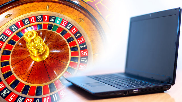 A laptop next to a tape measure. Concept - online casino. A computer next to a fragment of a roulette table. Concept - online casino games. Search for fortune. Games for money. Search for good luck.