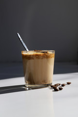 South Korean coffee dalgona – trendy cold latte or cappuccino with milk and cane sugar. Summer drink for breakfast