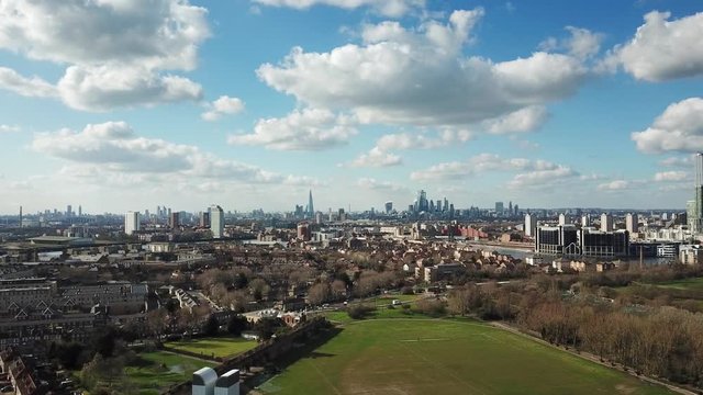 Magnificent aerial drone view of London and Thames river from above the Millwall Park