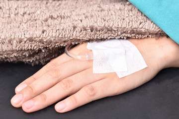Close up of saline solution on left hand of women