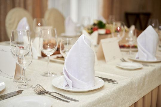 Table Set With Blank Guest Card, Plate With Serviette And Cutlery On Table, Copy Space. Place Setting At Wedding Reception. Table Served For Wedding Banquet In Restaurant