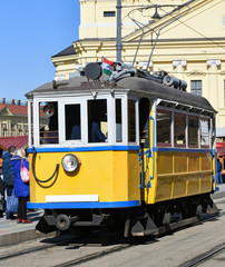 Fototapeta na wymiar Old yellow tram on the street