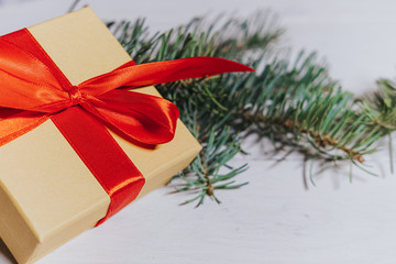 Christmas gift, pine twig decoration on a white table