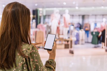 Young asian woman with shopping bags using smart phone and shopping at mall, Woman lifestyle concept