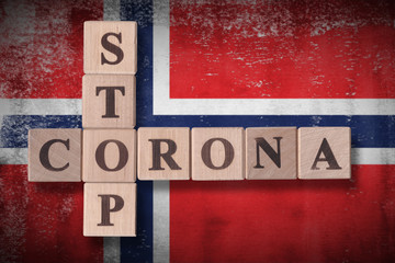 Flag of Norway with wooden cubes spelling STOP CORONA on it. 2019 - 2020 Novel Coronavirus (2019-nCoV) concept art, for an outbreak occurs in Norway.