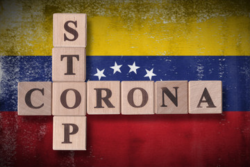 Flag of Venezuela with wooden cubes spelling STOP CORONA on it. 2019 - 2020 Novel Coronavirus (2019-nCoV) concept art, for an outbreak occurs in Venezuela.
