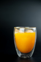 Freshly squeezed orange juice with ice cubes