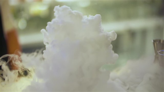 bartender preparing dry ice drink at club