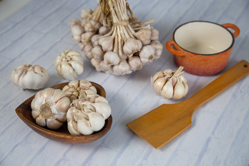 Garlic is placed on the white table in the kitchen, preparing for cooking, Concept: The ingredients of vegetarian ingredients are very much about nature for good health, background  aromatic herbs 