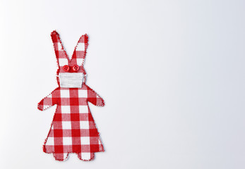Checkered fabric bunny girl with cotton face protection - Easter concept in coronavirus (COVID-19) time, copy space fot text