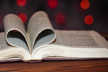 a open book with heart on background
