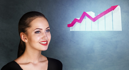 Business woman looks on increase schedule with growth arrow.