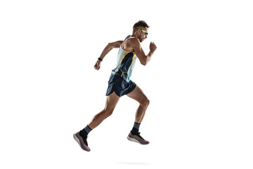 Fototapeta na wymiar Triathlon male athlete running isolated on white studio background. Caucasian fit jogger, triathlete training wearing sports equipment. Concept of healthy lifestyle, sport, action, motion. Side view.