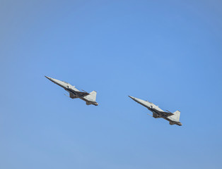 fighter jet military aircrafts flying showed with high speed on blue sky 