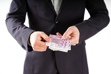Hands with euros banknote on business background.