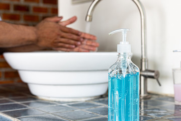 Young man is washing his hands in a sink sanitizing the colona virus for sanitation and reducing the spread of COVID-19 spreading throughout the world, Hygiene ,Sanitation concept.