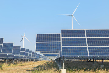 solar cells or solar panels or photovoltaic cells with wind turbines generating electricity alternative renewable wind energy and sunlight energy in hybrid power plant station is produce energy from n
