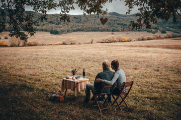 Couple together have lunch in autumn nature.