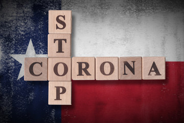 Flag of the state of Texas with wooden cubes spelling STOP CORONA on it. 2019 - 2020 Novel Coronavirus (2019-nCoV) concept art, for an outbreak occurs in Texas, US.