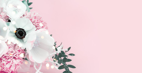 Close-up bouquet of flowers on a pink background, spring tulips of white color with hyacinth and buttercup. Banner with place for text and your advertisement.