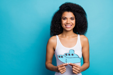 Close-up portrait of her she nice attractive lovely pretty cheerful cheery wavy-haired girl holding in hands ship paper form figure isolated on bright vivid shine vibrant blue color background