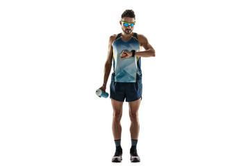 Triathlon male athlete running isolated on white studio background. Caucasian fit jogger, triathlete training wearing sports equipment. Concept of healthy lifestyle, sport, action, motion. Time check.