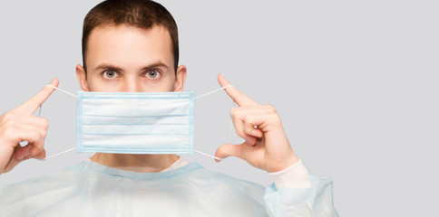 Portrait of young man wears protective mask and protective suit against air pollution or transmissible infectious diseases isolated on white